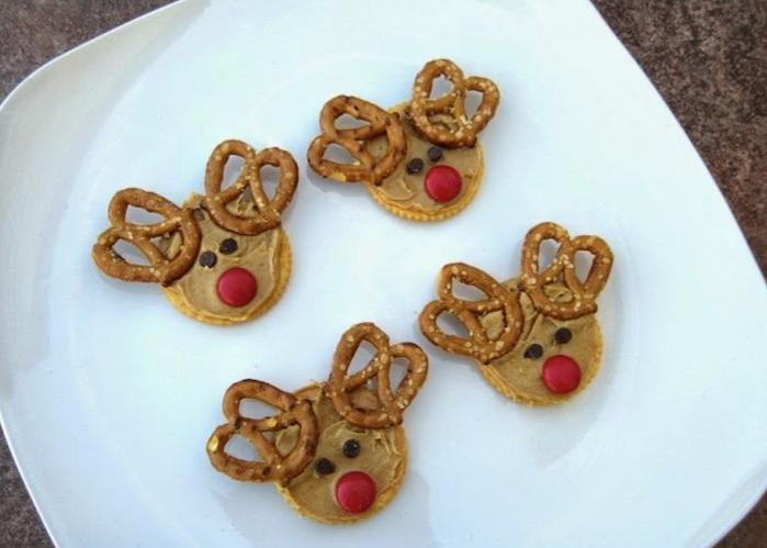 Four crackers on a plate to look like reindeer, with pretzels as antlers.